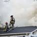 Firefighters create holes in the roof of a mobile home on fire in the 1515 block of Ridge Road in Superior Township on Tuesday. Daniel Brenner I AnnArbor.com